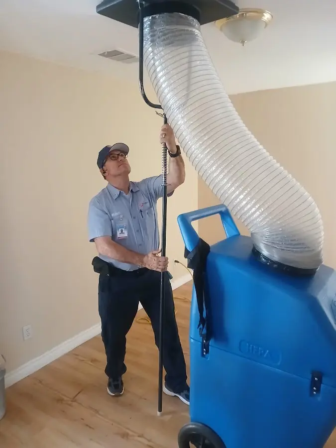 Furnace Tune-Up technician using HEPA equipment in Miles City